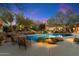 Inviting pool area with lush desert landscaping, cozy seating, and a serene ambiance for relaxation and entertaining at 10801 E Happy Valley Rd # 102, Scottsdale, AZ 85255