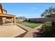 Spacious backyard with artificial turf, covered patio, and storage shed at 10813 W Saddlehorn Rd, Peoria, AZ 85383