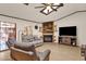 Living room with fireplace and view into kitchen area at 10837 S Shoshoni Dr, Phoenix, AZ 85044