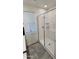 Clean bathroom features a large walk-in shower and gray tile flooring at 1629 W Buist Ave, Phoenix, AZ 85041