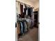 Large walk-in closet with double hanging rods and shelves at 1629 W Buist Ave, Phoenix, AZ 85041