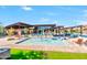 Community pool area showcasing splash pad, lounge seating, shade structures, and mature landscaping at 1712 W Dawn Dr, Tempe, AZ 85284