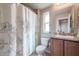 Bathroom with shower/tub combo, granite vanity, and linen closet at 17200 W Bell Rd # 873, Surprise, AZ 85374