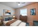 Bedroom featuring a king size bed, neutral toned walls, and colorful decor at 17200 W Bell Rd # 873, Surprise, AZ 85374