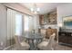 Dining room with a round table, white curtains, a chandelier, and built-in cabinets at 17200 W Bell Rd # 873, Surprise, AZ 85374