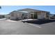 Tan mobile home with covered patio and parking area at 17200 W Bell Rd # 873, Surprise, AZ 85374
