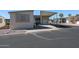 Tan mobile home with covered patio and parking area at 17200 W Bell Rd # 873, Surprise, AZ 85374