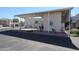 Tan mobile home with covered patio and parking area at 17200 W Bell Rd # 873, Surprise, AZ 85374