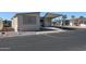 Tan mobile home with covered patio and parking area at 17200 W Bell Rd # 873, Surprise, AZ 85374