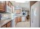 Open kitchen features a large island, updated appliances, and tile flooring at 17200 W Bell Rd # 873, Surprise, AZ 85374