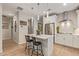 Modern kitchen island with white cabinets and stainless steel appliances at 2038 E Dry Wood Rd, Phoenix, AZ 85024