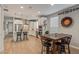 Modern kitchen with white cabinets, island, and dining area at 2038 E Dry Wood Rd, Phoenix, AZ 85024