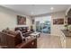 Bright living room with leather sofas, view of backyard pool, and large artwork at 2038 E Dry Wood Rd, Phoenix, AZ 85024