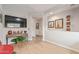 Living area with hardwood floors and a large TV at 2038 E Dry Wood Rd, Phoenix, AZ 85024