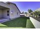 Large backyard with grassy lawn, covered patio and block wall at 2234 E 37Th Ave, Apache Junction, AZ 85119