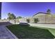 Landscaped backyard with grassy area and block retaining wall at 2234 E 37Th Ave, Apache Junction, AZ 85119