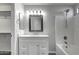 Updated bathroom with white vanity, shower/tub combo, and large mirror at 2234 E 37Th Ave, Apache Junction, AZ 85119