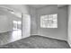 Bright bedroom with carpet flooring, window, and access to another room at 2234 E 37Th Ave, Apache Junction, AZ 85119