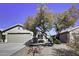 One-story house with a two-car garage, mature tree, and well-maintained landscaping at 2234 E 37Th Ave, Apache Junction, AZ 85119