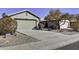 Single-story home with a two-car garage and neatly landscaped yard at 2234 E 37Th Ave, Apache Junction, AZ 85119
