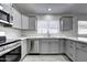 L-shaped kitchen with gray cabinets and stainless steel appliances at 2234 E 37Th Ave, Apache Junction, AZ 85119