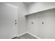 Laundry room with built-in shelving and door to exterior at 2234 E 37Th Ave, Apache Junction, AZ 85119