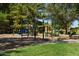 Neighborhood playground area with slides, climbing structures, and mature shade trees at 2234 E Stephens Rd, Gilbert, AZ 85296