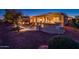 Evening view of backyard patio with fire pit and seating at 22819 N Del Monte Dr, Sun City West, AZ 85375