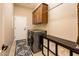 Bright laundry room, featuring washer, dryer, cabinets, and built-in storage at 22819 N Del Monte Dr, Sun City West, AZ 85375