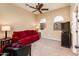 Cozy sitting room with red couch, comfy armchair, and TV at 22819 N Del Monte Dr, Sun City West, AZ 85375