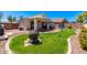 Spacious backyard with a grassy area and fire pit at 29127 N Mountain View Rd, San Tan Valley, AZ 85143