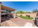 Landscaped backyard with a curved lawn and a fire pit at 29127 N Mountain View Rd, San Tan Valley, AZ 85143