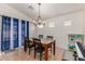 Dining area with a wooden table and blue curtains at 29127 N Mountain View Rd, San Tan Valley, AZ 85143