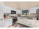 White kitchen with granite countertops and stainless steel appliances at 29127 N Mountain View Rd, San Tan Valley, AZ 85143
