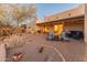 Cozy outdoor patio with comfortable seating, desert landscaping, and covered area at 38860 N School House Rd, Cave Creek, AZ 85331