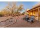 Inviting back patio with seating area and desert landscaping; perfect for outdoor relaxation at 38860 N School House Rd, Cave Creek, AZ 85331