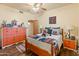 Bedroom boasts a bed, wood floors, ceiling fan, and closet at 38860 N School House Rd, Cave Creek, AZ 85331