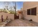 Exterior shot showing decorative metal artwork at gate and desert landscaping at 38860 N School House Rd, Cave Creek, AZ 85331