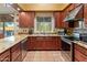 This kitchen features wood cabinets, stainless appliances and a tiled floor at 38860 N School House Rd, Cave Creek, AZ 85331