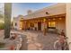 Covered patio area of desert home, with string lights, stucco walls and stone walkway at 38860 N School House Rd, Cave Creek, AZ 85331