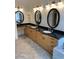 Bright bathroom featuring dual vanities with granite countertops and stylish fixtures at 4119 E Glencove St, Mesa, AZ 85205