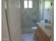 Bright bathroom featuring a marble shower with glass door, marble floors, and modern vanity at 4119 E Glencove St, Mesa, AZ 85205