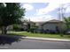 Charming home with a red tile roof, circular driveway and lush, green landscaping at 4119 E Glencove St, Mesa, AZ 85205