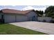 Spacious three-car garage with extended driveway and low maintenance desert landscaping at 4119 E Glencove St, Mesa, AZ 85205