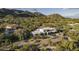 An aerial view of a modern home with a backyard pool, surrounded by lush greenery in a desert landscape at 4451 E Joshua Tree Ln, Paradise Valley, AZ 85253