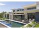 Stunning modern home featuring a pool, outdoor seating, and desert landscaping for luxurious living at 4451 E Joshua Tree Ln, Paradise Valley, AZ 85253