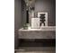 Stylish powder room featuring a marble floating counter, modern lighting and attractive artwork at 4451 E Joshua Tree Ln, Paradise Valley, AZ 85253