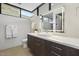 Bright bathroom with long vanity with white counter and dark cabinets plus bright mirror at 4451 E Joshua Tree Ln, Paradise Valley, AZ 85253