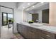Modern bathroom boasts dual sinks, sleek wood cabinetry, and mountain views from the adjacent office at 4451 E Joshua Tree Ln, Paradise Valley, AZ 85253