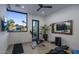 Bright exercise room with stationary bike, weight bench, TV, and large window views at 4451 E Joshua Tree Ln, Paradise Valley, AZ 85253